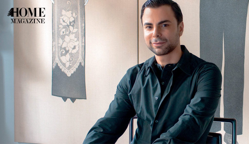 Young man wearing black clothes smiling and sitting on chair