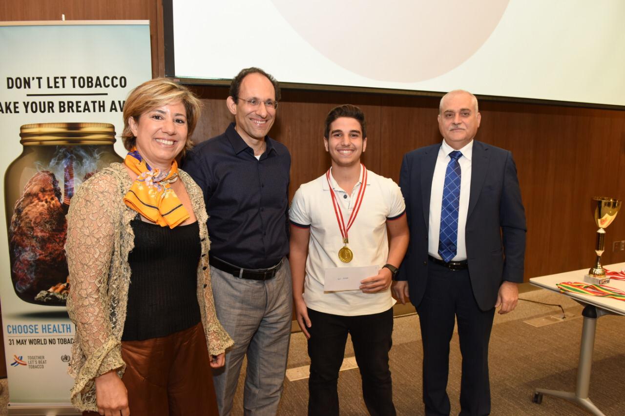 Two men, One woman and one boy standing