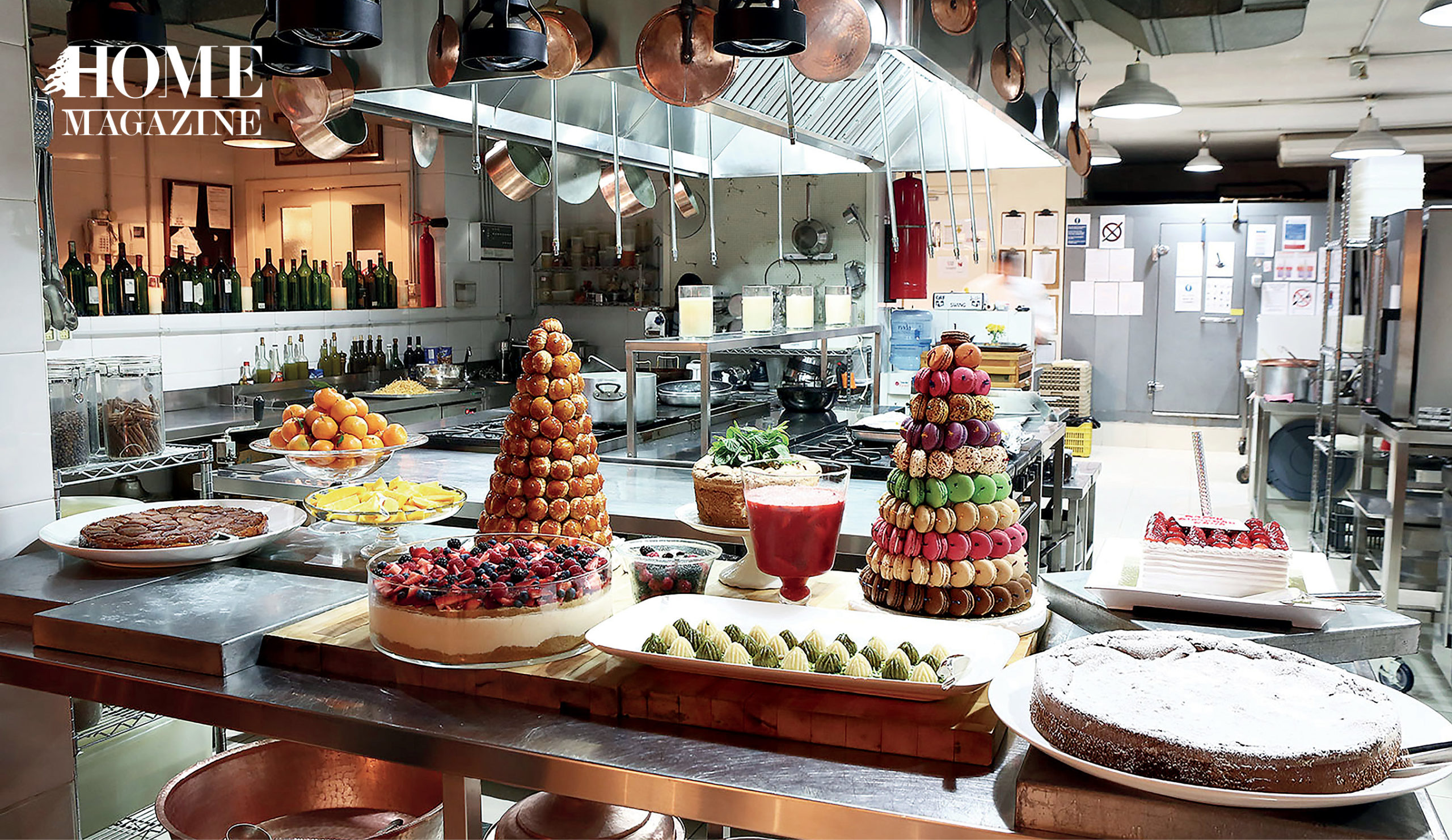 Setup of cakes, fruits and deserts in a kitchen